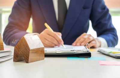 Midsection of man sitting on table