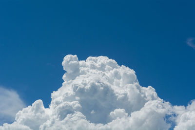 Low angle view of cumulonimbus clouds in blue sky.