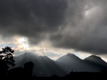 Scenic view of mountains against cloudy sky