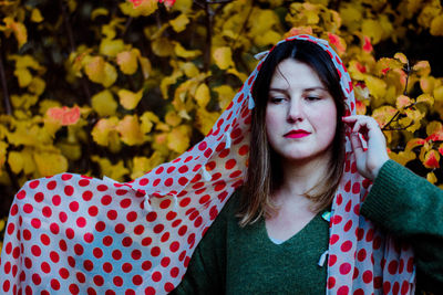 Portrait of beautiful young woman in park