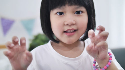 Portrait of girl gesturing at home