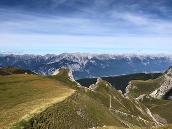 Scenic view of snowcapped mountain against cloudy sky