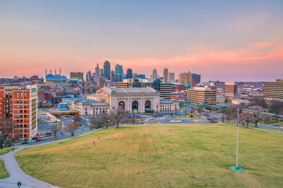 Buildings in city during sunset