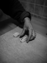 Cropped hand of woman preparing food at home