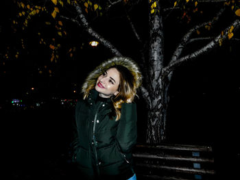 Young woman in illuminated tree