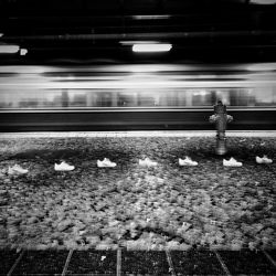 Rear view of person standing at railroad station at night