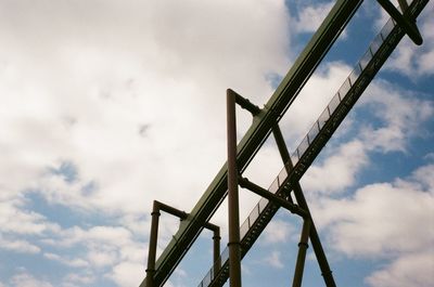 Low angle view of crane against sky