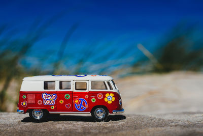 Toy van on rock at beach