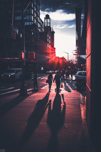 People on city street during sunset