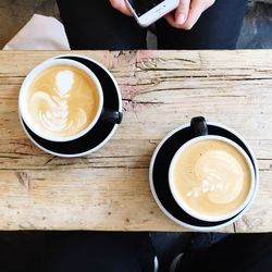 Close-up of hand holding coffee cup