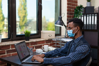 Businessman wearing mask working at office