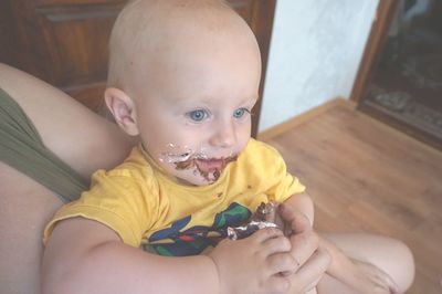 Close-up of cute baby boy eating cake