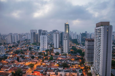 High angle view of modern buildings in city against sky