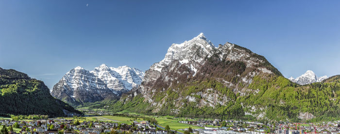 Panoramic view of mountains against clear blue sky