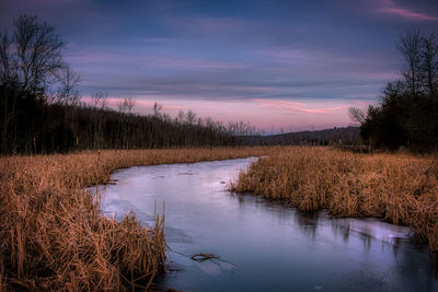 Scenic view of lake against sky during sunset