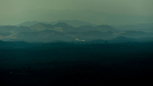 Scenic view of silhouette mountains against sky at dusk