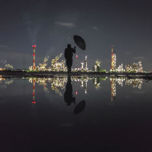 Silhouette of man standing in water