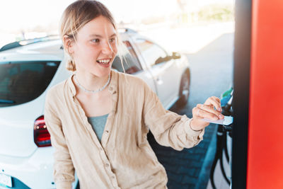 Young man using mobile phone in car