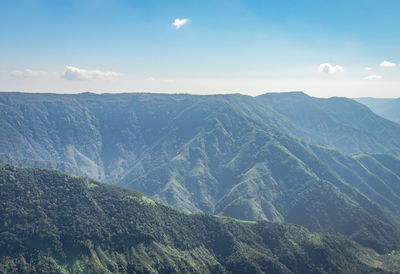 Misty mountain range covered with white mist and amazing blue sky