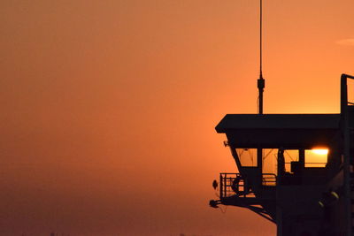 Low angle view of silhouette built structure against clear sky