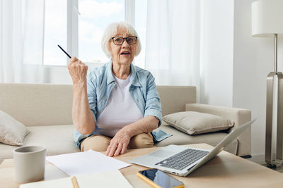 Young woman using laptop at home