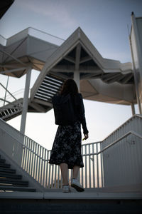 Low angle view of women walking on staircase