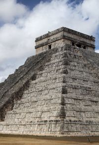 Low angle view of historical building against cloudy sky