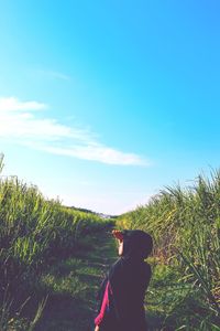 Man standing on field against sky