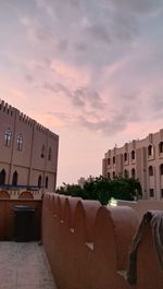 Buildings in city during sunset