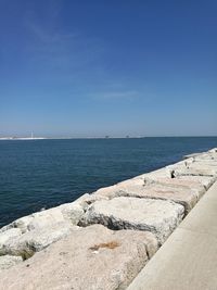 Scenic view of sea against blue sky