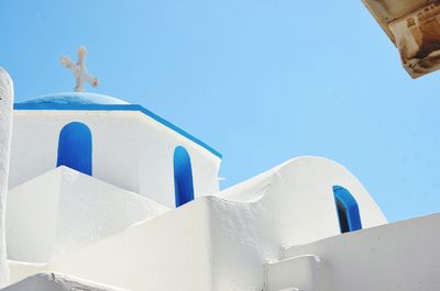 Low angle view of white church in santorini against clear sky