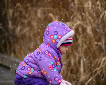 Cute girl playing outdoors during winter