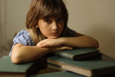 Portrait of child on a desk with books