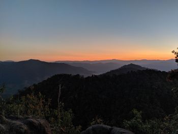 Scenic view of silhouette mountains against sky at sunset
