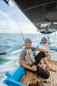 Rear view of woman sitting on boat