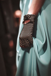 Female fashion details of creative glove and blue stylish skirt material