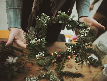 Midsection of woman holding wreath 