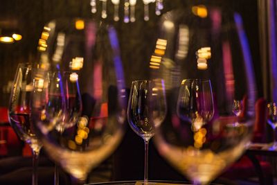 Empty wineglasses on table in illuminated restaurant