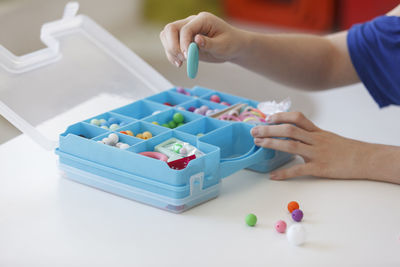 High angle view of child playing with multi colored table