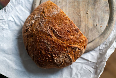 Close-up of hand holding bread on table