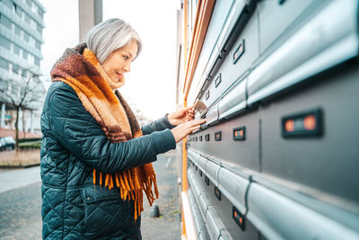 Side view of woman opening lock