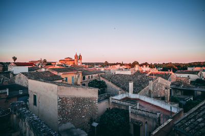 High angle shot of townscape against sky at sunset