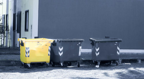 Garbage bin against buildings in city