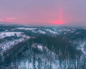 Scenic view of snow covered landscape against sky during sunset