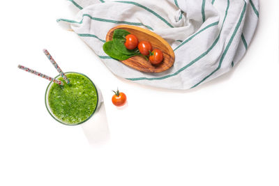 High angle view of fruits in bowl over white background