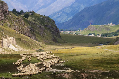 Scenic view of landscape and mountains against sky