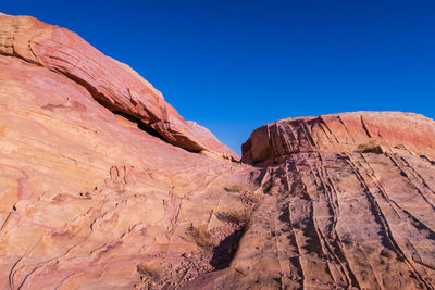 Low angle landscape of pink and purple jagged rock at valley of fire state park in nevada