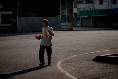 Full length of man walking on road