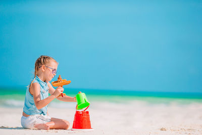 Boy holding toy on beach