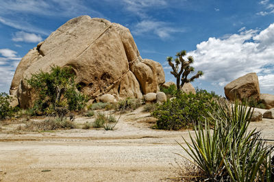 Rock formations on landscape against sky